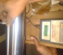 Hard chrome coating thickness being checked with a gauge before grinding